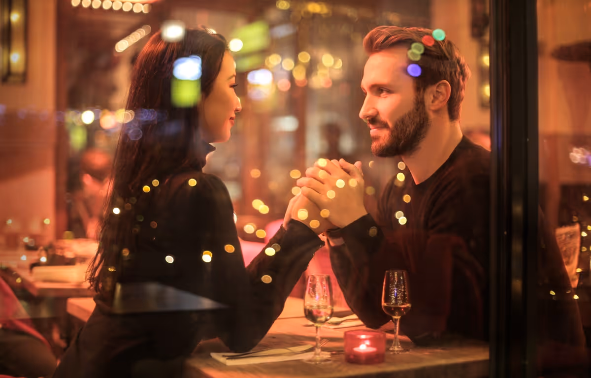 Couple holding hands at the restaurant